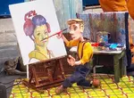 古巴藝術家Victor Ariosa的《小木偶操縱畫》,不是畫家執筆而是讓木偶拿筆繪圖的表演藝術 古巴藝術家Victor Ariosa的《小木偶操縱畫》,不是畫家執筆而是讓木偶拿筆繪圖的表演藝術
