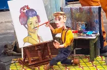 古巴藝術家Victor Ariosa的《小木偶操縱畫》，不是畫家執筆而是讓木偶拿筆繪圖的表演藝術